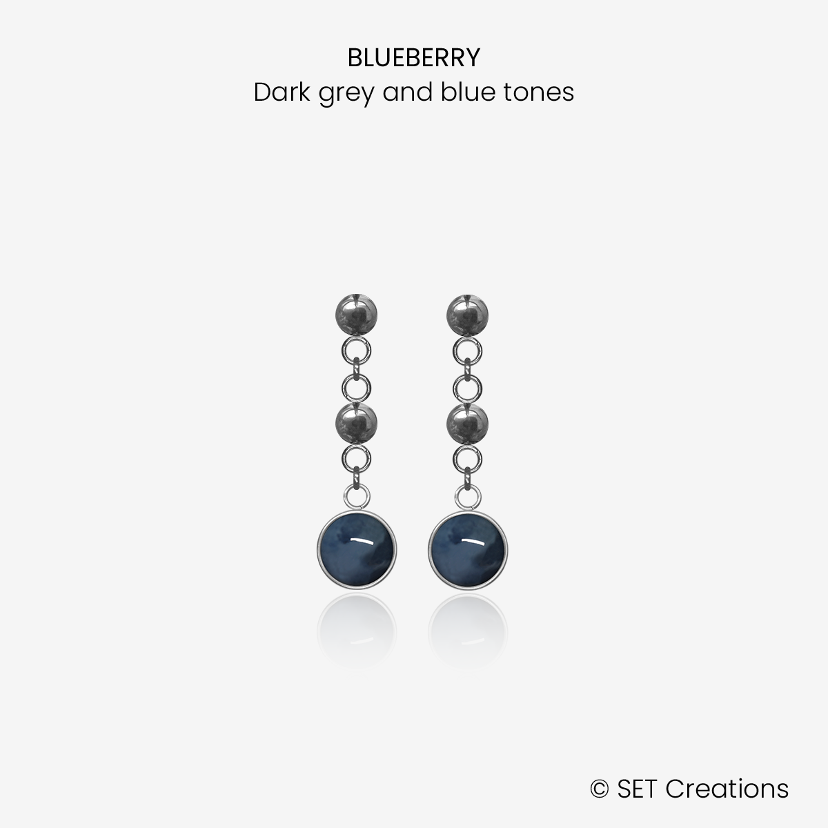 1 pair of 6mm fused glass circular cabochons set into steel bases, attached to steel ball studs via steel ball connectors. Cabochon colour: Blueberry = dark grey and blue marble effect.