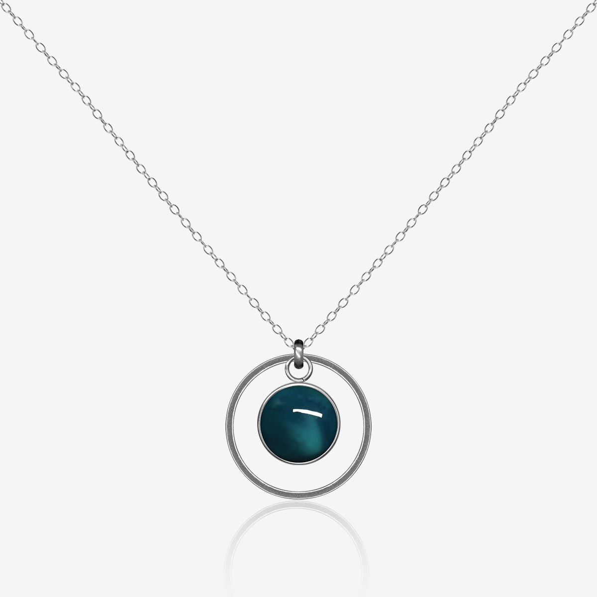 10mm fused glass circular cabochon set into a steel base, framed with a 20mm steel hoop and attached to a 500mm stainless steel pendant chain via jump ring. Cabochon colour: Ocean = deep turquoise and aqua marble effect.