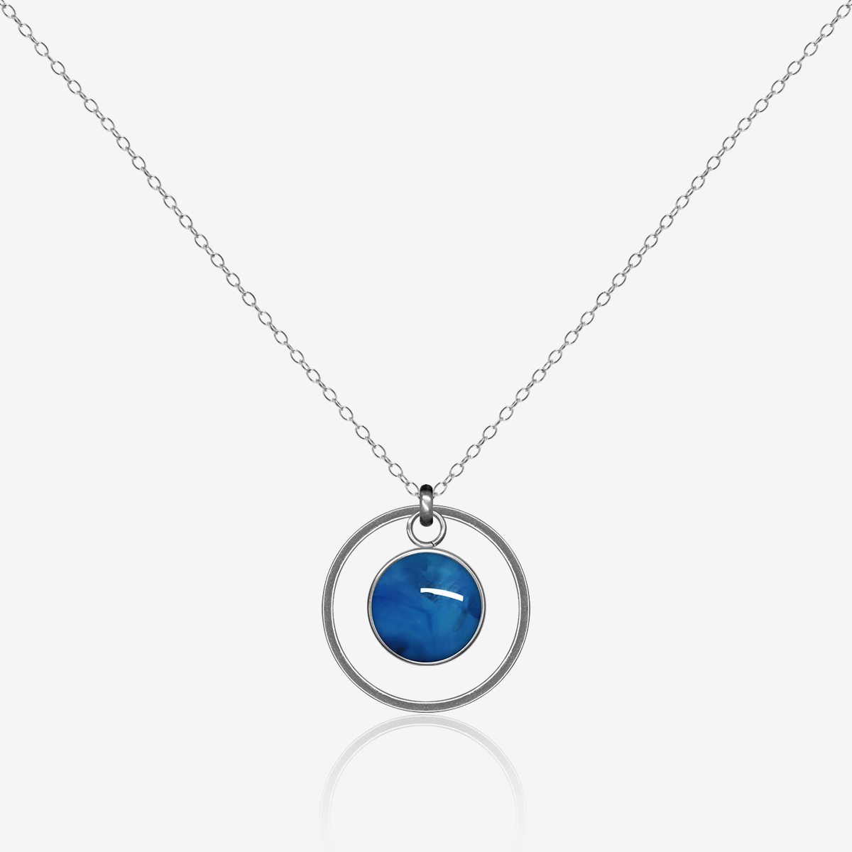 10mm fused glass circular cabochon set into a steel base, framed with a 20mm steel hoop and attached to a 500mm stainless steel pendant chain via jump ring. Cabochon colour: Blue Orchid = bright and rich blue marble effect.
