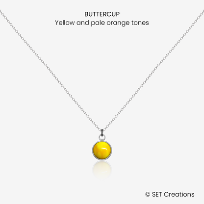 6mm fused glass circular cabochon set into a steel base and attached to a 400mm stainless steel pendant chain via jump ring. Cabochon colour: Buttercup = yellow and pale orange marble effect.