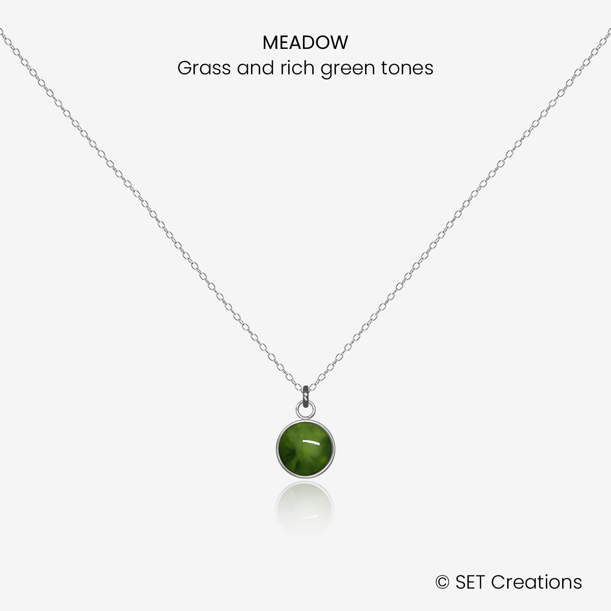 6mm fused glass circular cabochon set into a steel base and attached to a 400mm stainless steel pendant chain via jump ring. Cabochon colour: Meadow = grass and rich green marble effect.