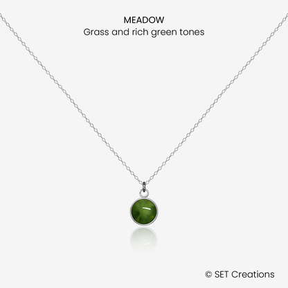 6mm fused glass circular cabochon set into a steel base and attached to a 400mm stainless steel pendant chain via jump ring. Cabochon colour: Meadow = grass and rich green marble effect.