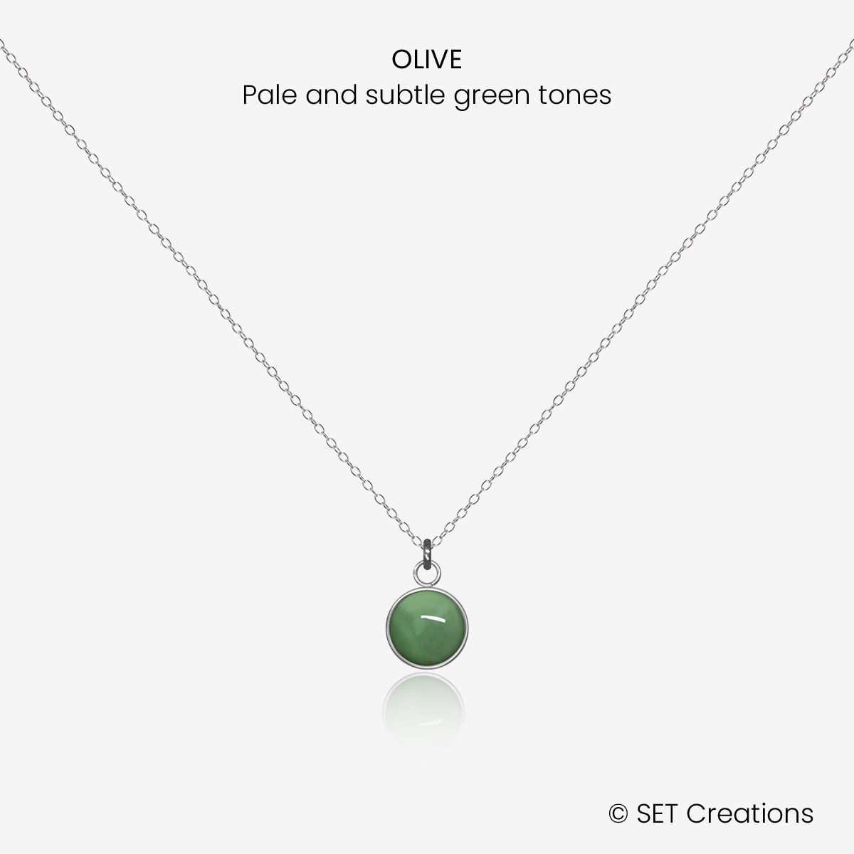 6mm fused glass circular cabochon set into a steel base and attached to a 400mm stainless steel pendant chain via jump ring. Cabochon colour: Olive = pale and subtle green marble effect.