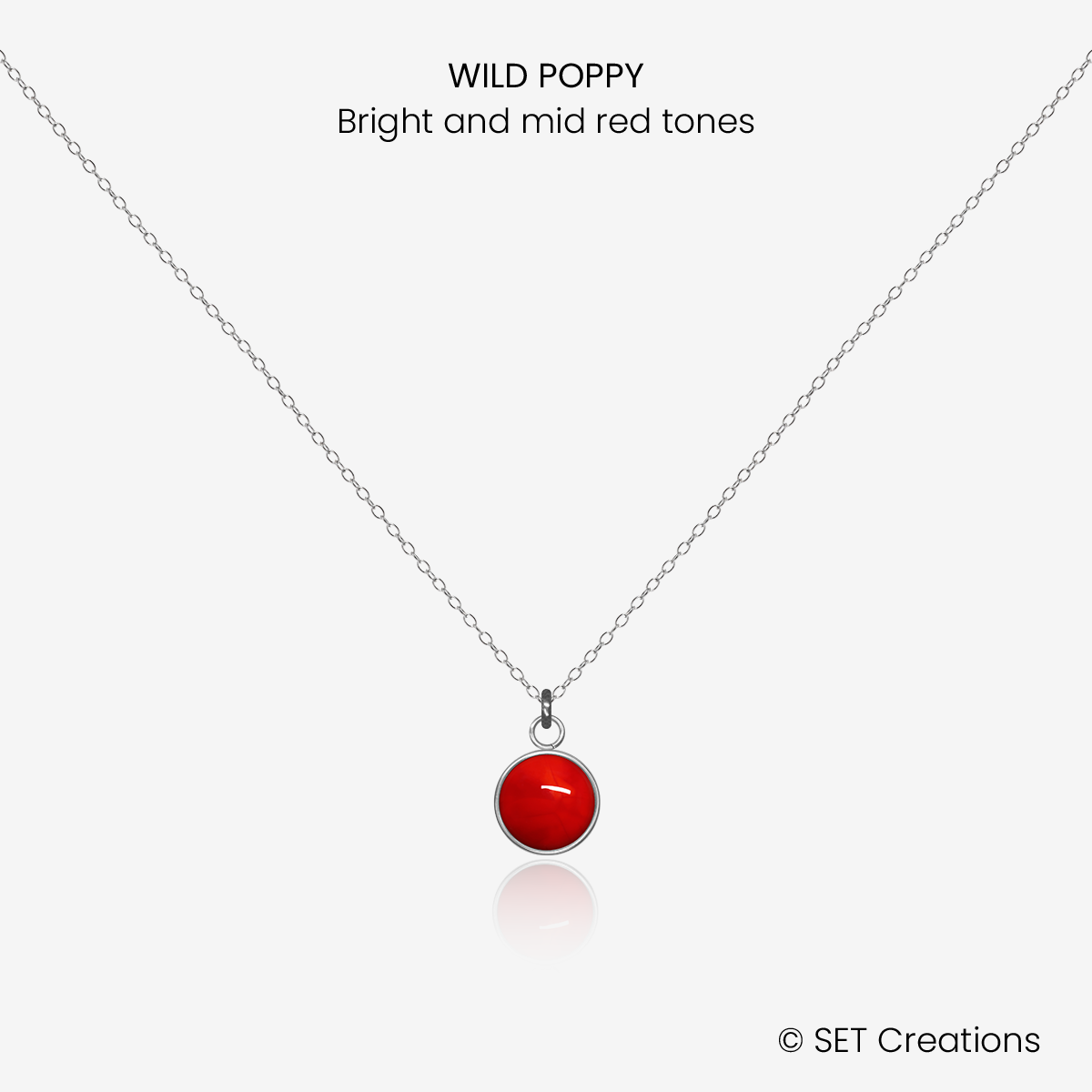6mm fused glass circular cabochon set into a steel base and attached to a 400mm stainless steel pendant chain via jump ring. Cabochon colour: Wild Poppy = bright and mid red marble effect.