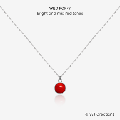 6mm fused glass circular cabochon set into a steel base and attached to a 400mm stainless steel pendant chain via jump ring. Cabochon colour: Wild Poppy = bright and mid red marble effect.