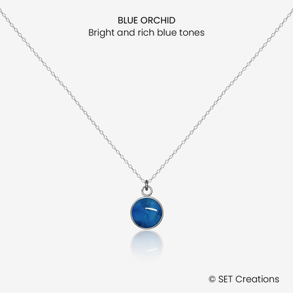 8mm fused glass circular cabochon set into a steel base and attached to a 500mm stainless steel pendant chain via jump ring. Cabochon colour: Blue Orchid = bright and rich blue marble effect.