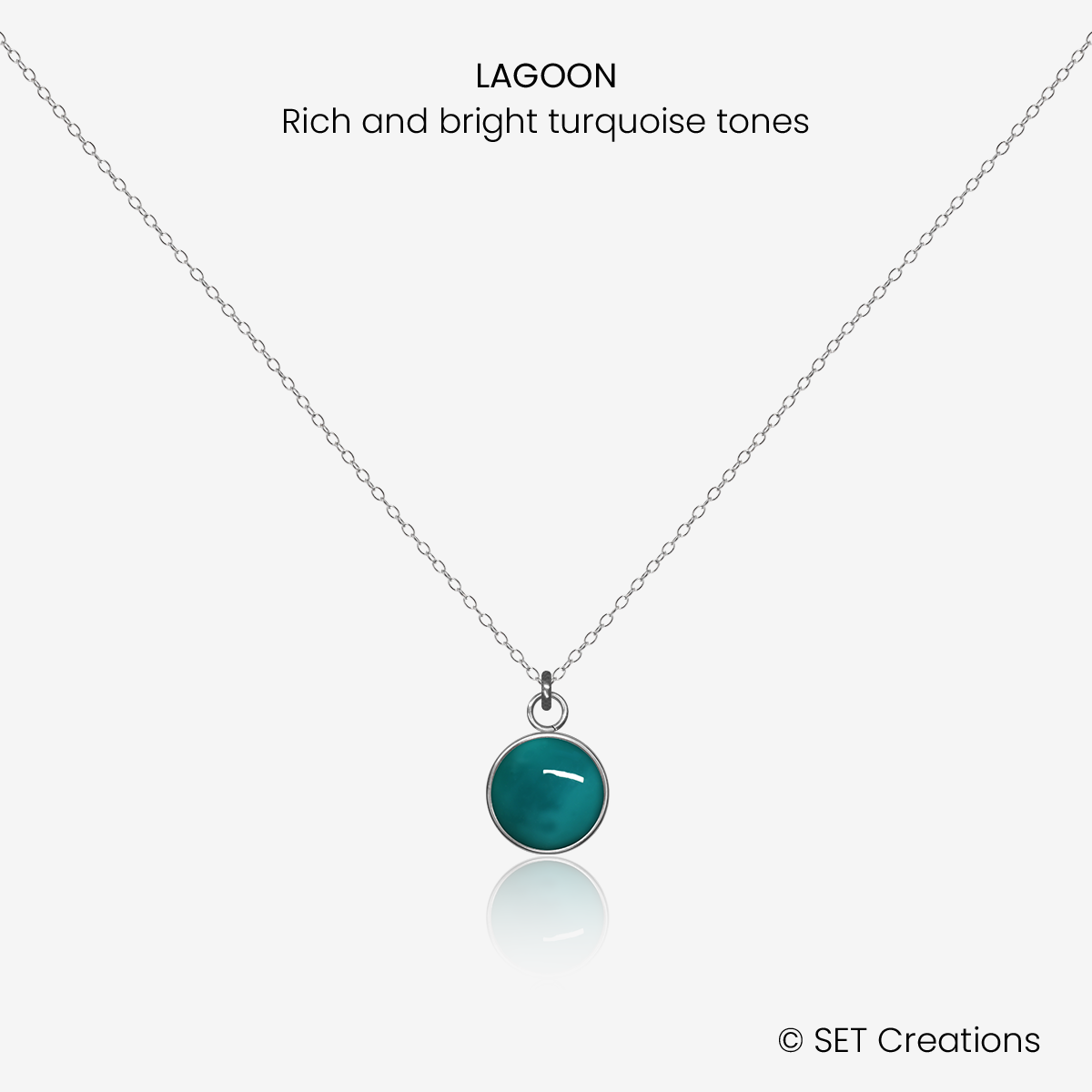 8mm fused glass circular cabochon set into a steel base and attached to a 500mm stainless steel pendant chain via jump ring. Cabochon colour: Lagoon = rich and bright turquoise marble effect.