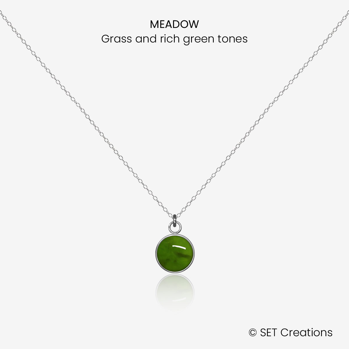 8mm fused glass circular cabochon set into a steel base and attached to a 500mm stainless steel pendant chain via jump ring. Cabochon colour: Meadow = grass and rich green marble effect.