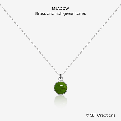 8mm fused glass circular cabochon set into a steel base and attached to a 500mm stainless steel pendant chain via jump ring. Cabochon colour: Meadow = grass and rich green marble effect.