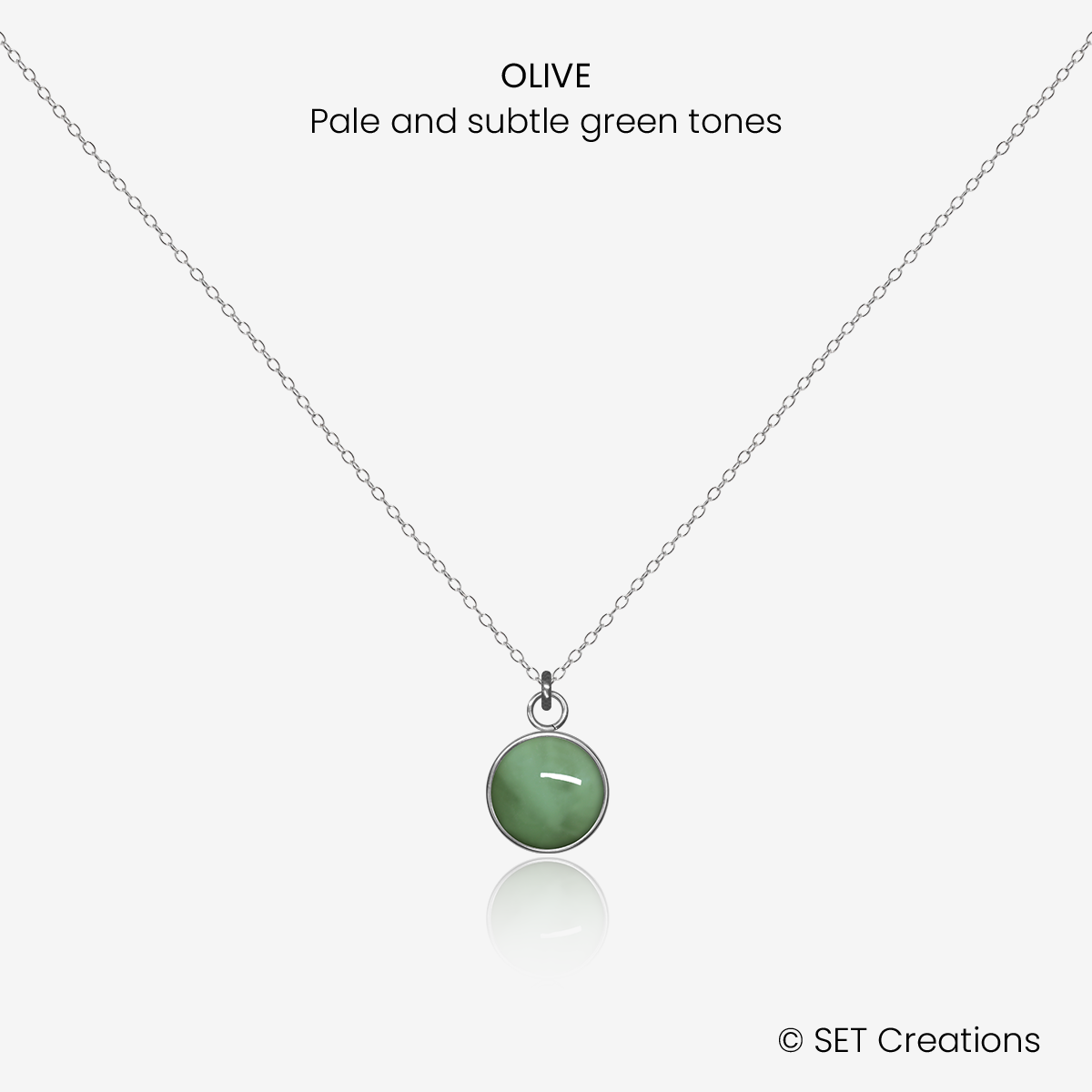 8mm fused glass circular cabochon set into a steel base and attached to a 500mm stainless steel pendant chain via jump ring. Cabochon colour: Olive = pale and subtle green marble effect.