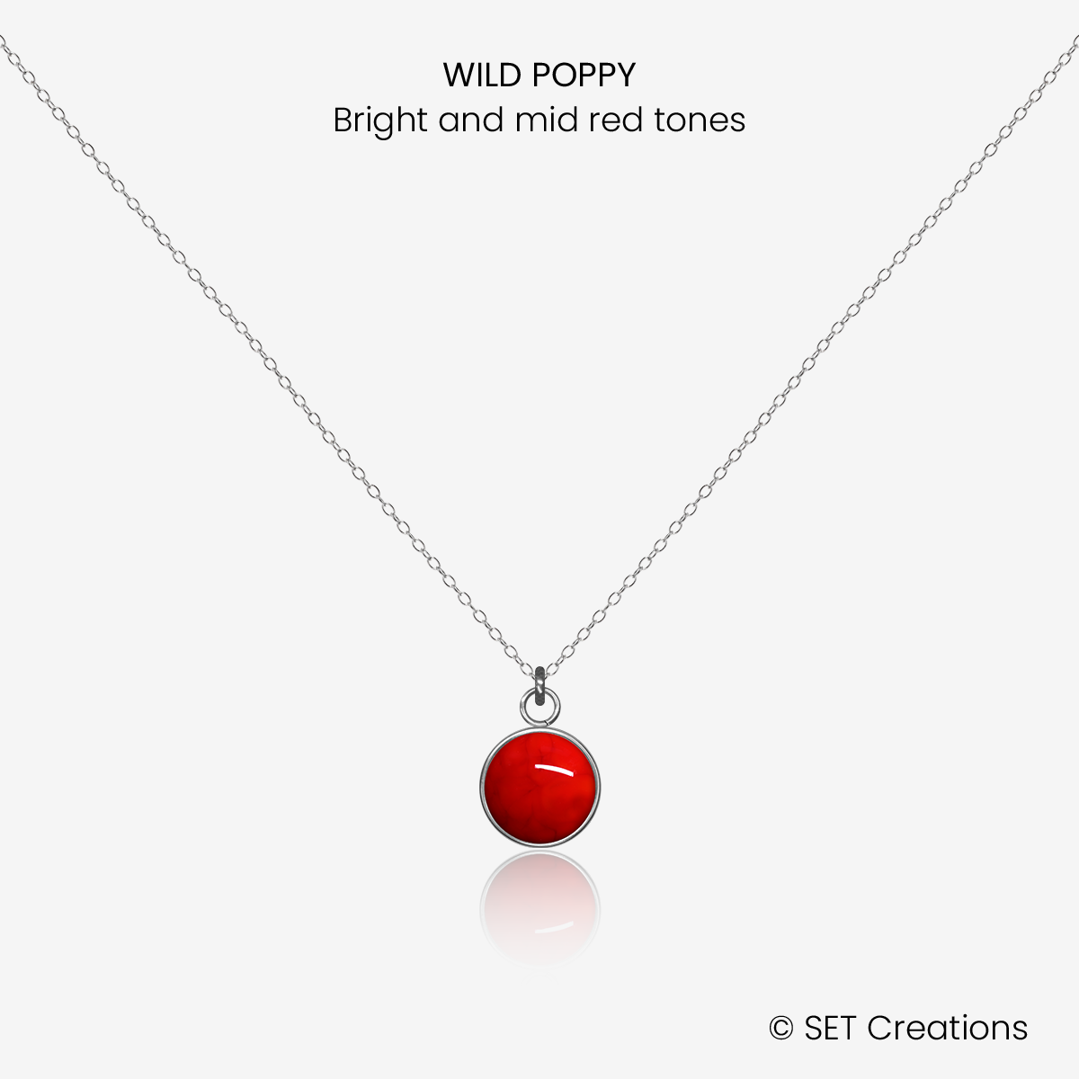 8mm fused glass circular cabochon set into a steel base and attached to a 500mm stainless steel pendant chain via jump ring. Cabochon colour: Wild Poppy = bright and mid red marble effect.
