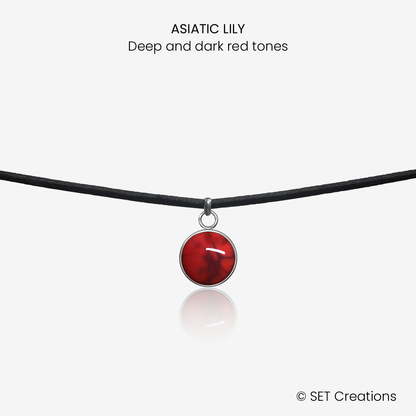 10mm fused glass circular cabochon set into a steel base and attached to a 380mm faux suede black cord via jump ring.  Cabochon colour: Asiatic Lily = deep and dark red marble effect.