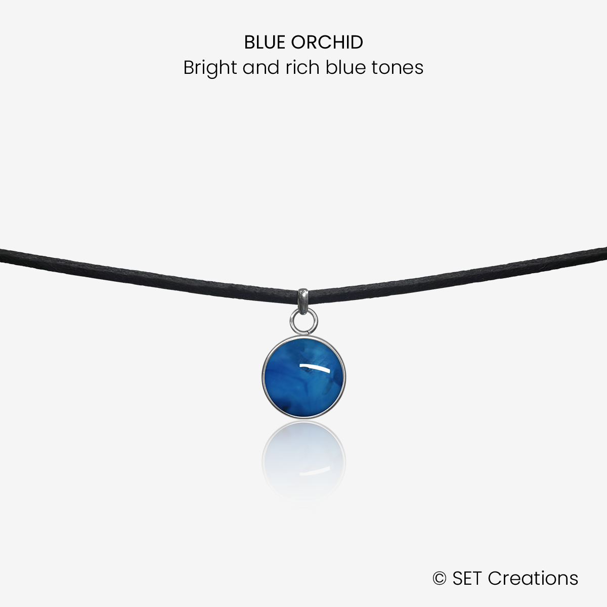 10mm fused glass circular cabochon set into a steel base and attached to a 380mm faux suede black cord via jump ring. Cabochon colour: Blue Orchid = bright and rich blue marble effect.