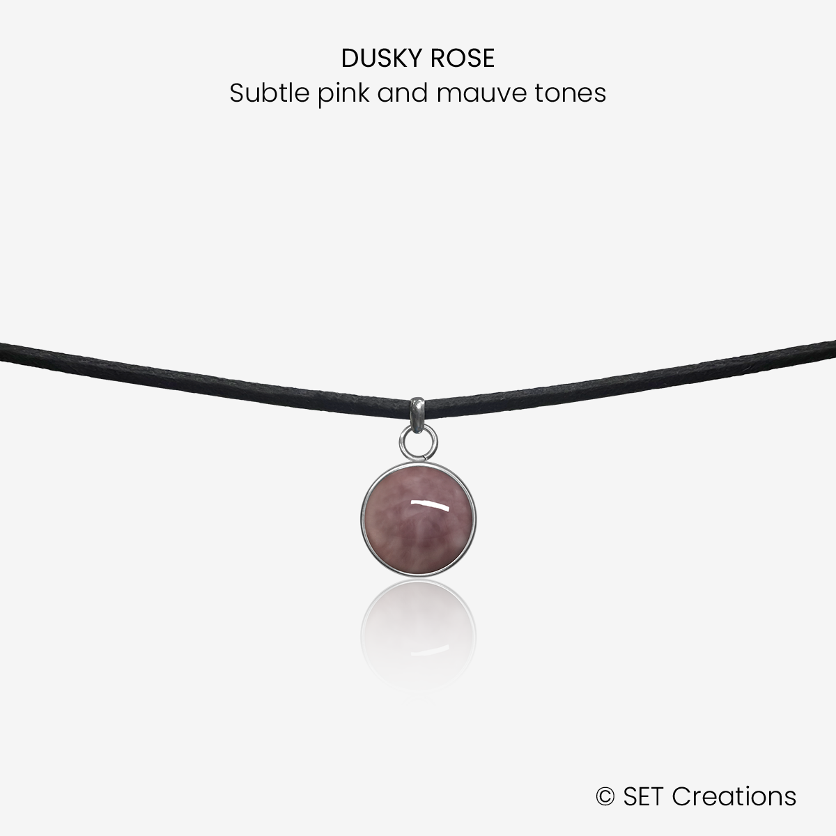 10mm fused glass circular cabochon set into a steel base and attached to a 380mm faux suede black cord via jump ring. Cabochon colour: Dusky Rose = subtle pink and mauve marble effect.