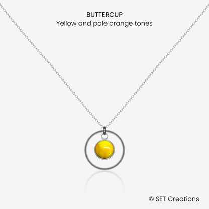 6mm fused glass circular cabochon set into a steel base, framed with a 16mm steel hoop and attached to a 400mm stainless steel pendant chain via jump ring. Cabochon colour: Buttercup = yellow and pale orange marble effect.