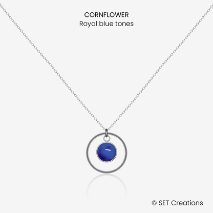 6mm fused glass circular cabochon set into a steel base, framed with a 16mm steel hoop and attached to a 400mm stainless steel pendant chain via jump ring. Cabochon colour: Cornflower = royal blue marble effect.