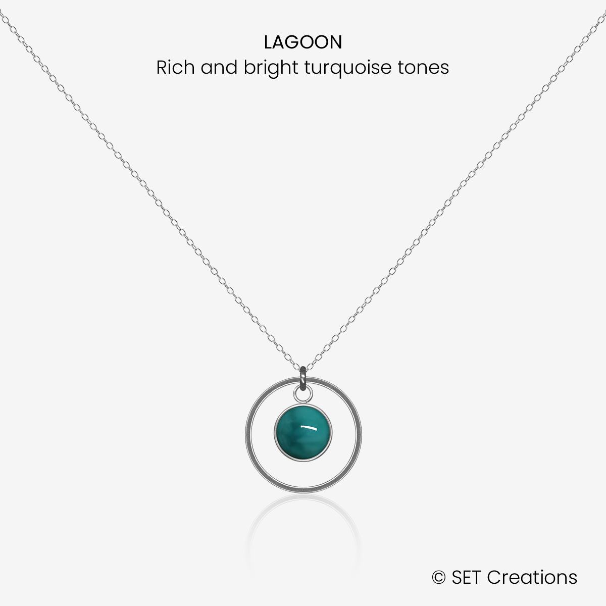 6mm fused glass circular cabochon set into a steel base, framed with a 16mm steel hoop and attached to a 400mm stainless steel pendant chain via jump ring. Cabochon colour: Lagoon = rich and bright turquoise marble effect.