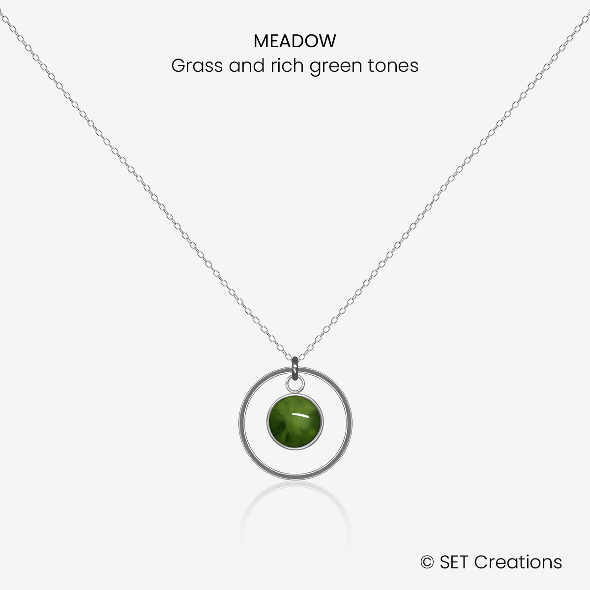 6mm fused glass circular cabochon set into a steel base, framed with a 16mm steel hoop and attached to a 400mm stainless steel pendant chain via jump ring. Cabochon colour: Meadow = grass and rich green marble effect.