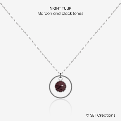 6mm fused glass circular cabochon set into a steel base, framed with a 16mm steel hoop and attached to a 400mm stainless steel pendant chain via jump ring. Cabochon colour: Night Tulip = maroon and black marble effect.