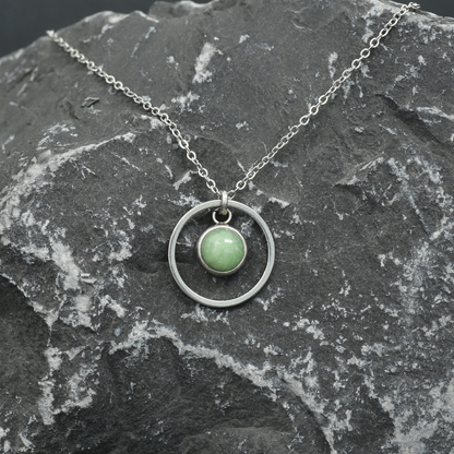 6mm fused glass circular cabochon set into a steel base, framed with a 16mm steel hoop and attached to a 400mm stainless steel pendant chain via jump ring. Cabochon colour: Olive = pale and subtle green marble effect.