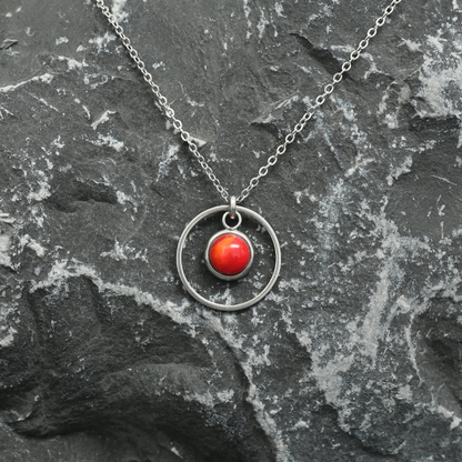 6mm fused glass circular cabochon set into a steel base, framed with a 16mm steel hoop and attached to a 400mm stainless steel pendant chain via jump ring. Cabochon colour: Wild Poppy = bright and mid red marble effect.
