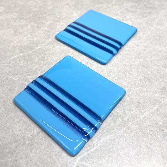 fused glass square coasters. Size 100mm X 100mm. Blue base with 3 narrow darker blue stripes. Set of 2