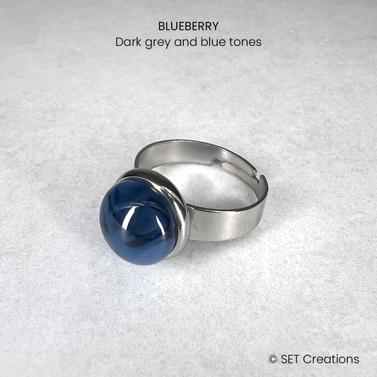 10mm fused glass circular cabochons set into stainless steel adjustable chunky ring bases. Cabochon colour: Blueberry = dark grey and blue marble effect.